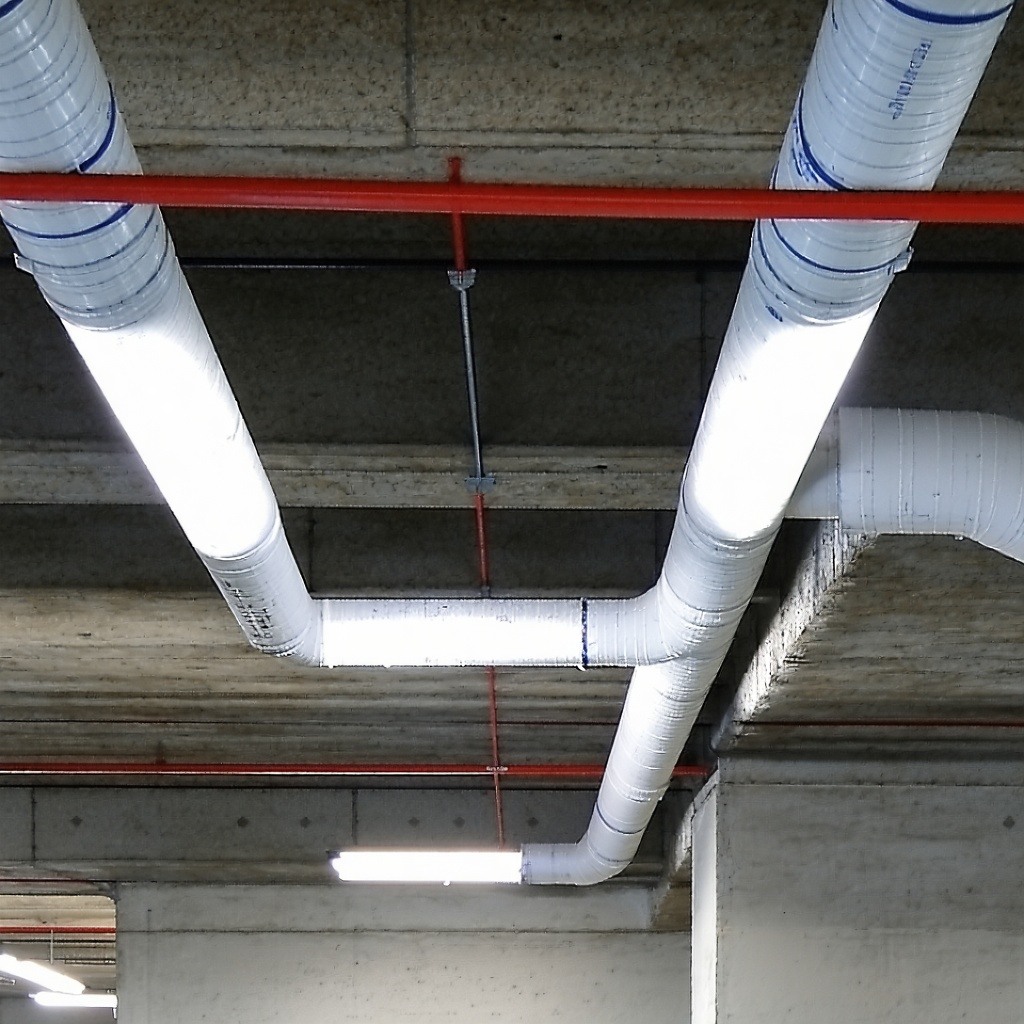 pipe penetrating the internal ceiling of a building, perhaps in the underground carpark, without passive fire protection